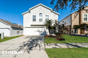 Riverview house for rent - A white house with a brown roof and a garage door is shown.