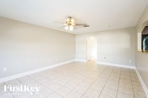 Riverview house for rent - A spacious room with a ceiling fan and tiled floor.
