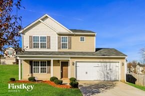 Winston Salem house for rent - a yellow house with a white garage door