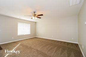Winston Salem house for rent - a bedroom with carpet and a ceiling fan