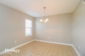 Winston Salem house for rent - an empty dining room with tiled floors and a window