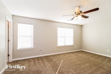 Winston Salem house for rent - a living room with carpet and a ceiling fan