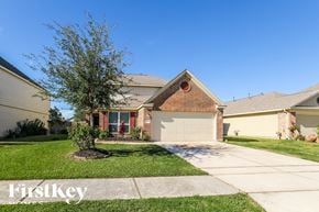 Baytown house for rent - a house with a garage and a lawn