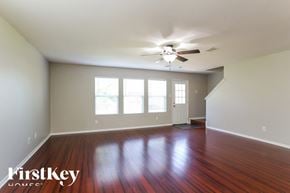 Baytown house for rent - a living room with wood floors and a ceiling fan