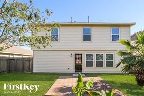 Baytown house for rent - the front of a white house with a yard and a walkway