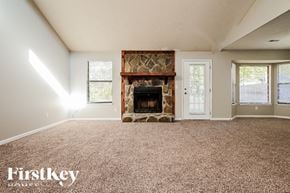 Jonesboro house for rent - A room with a fireplace and a carpeted floor.