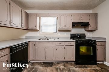 Jonesboro house for rent - A kitchen with a black oven and pink cabinets.
