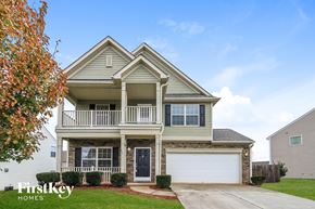 Lexington house for rent - A two-story house with a balcony and a garage.