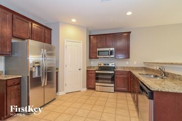 Lexington house for rent - A kitchen with brown cabinets and a refrigerator.