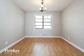 Lawrenceville house for rent - A room with wooden flooring and a window with blinds.