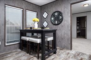 San Leon apartment for rent - a dining room with a table and a clock on the wall