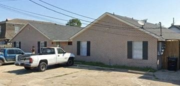New Orleans apartment for rent - a white truck parked in front of a brick house