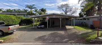 Escondido apartment for rent - a car parked in a carport in front of a house