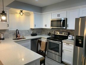Bay City apartment for rent - a kitchen with stainless steel appliances and white cabinets