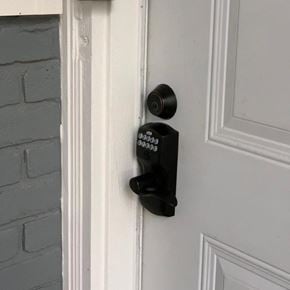 Bay City apartment for rent - a black coded door lock on a white door