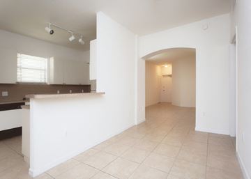 Homestead apartment for rent - A kitchen with white cabinets and a countertop is shown.