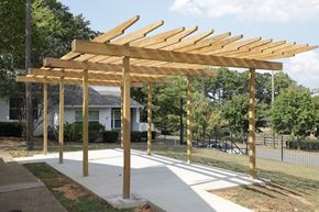 Birmingham apartment for rent - a wooden pergola in a yard with a house in the background