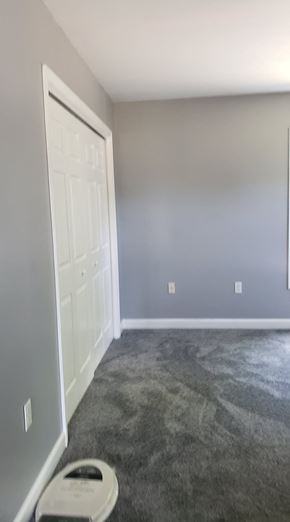 Girdletree house for rent - A room with a carpeted floor and a white door.