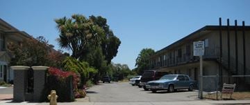 Hayward apartment for rent - a street with cars parked in front of a building