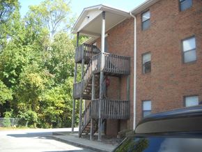 Kernersville apartment for rent - a building with a balcony and a car parked next to it