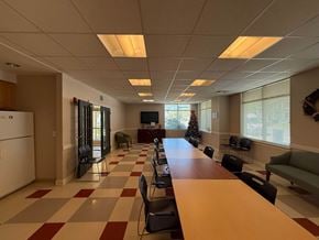 New Haven apartment for rent - A room with a long table and chairs, a television, and a Christmas tree.