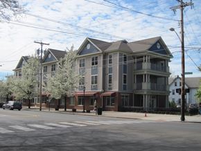 New Haven apartment for rent - A large building with a red awning sits on the corner of a street.
