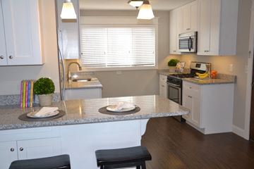 St. Louis Park apartment for rent - a kitchen with granite counter tops and white cabinets