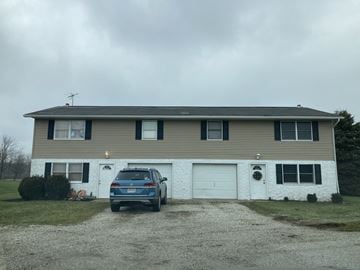 Hartville apartment for rent - A house with a car parked in front of it.