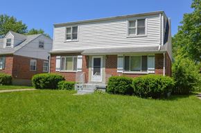 Cincinnati apartment for rent - A house with a white siding and a brick facade with a small porch.