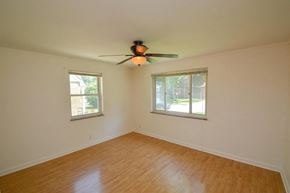 Cincinnati apartment for rent - A room with a ceiling fan and two windows.