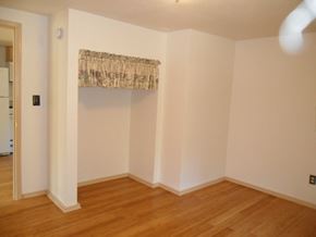 Kenai apartment for rent - A room with wooden floors and a window with a curtain.