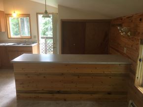 Soldotna apartment for rent - a kitchen with a bar in the middle of a room