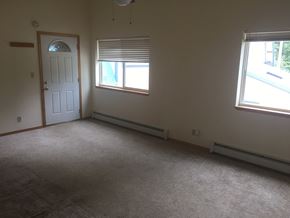 Soldotna apartment for rent - an empty room with two windows and a door