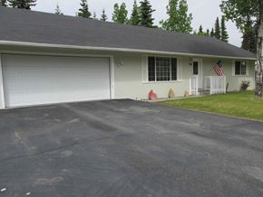 Soldotna house for rent - A house with a grey roof and a white garage door.