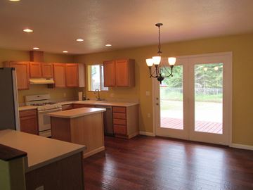 Soldotna house for rent - A kitchen with wooden cabinets and a white refrigerator.
