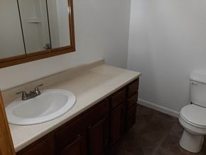 Soldotna house for rent - A white toilet sits next to a sink in a bathroom.