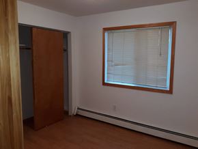 Soldotna house for rent - A room with a brown door and a window with blinds.