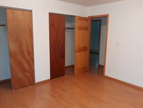 Soldotna house for rent - Three doors in a room with wooden floors.