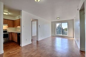 Brossard apartment for rent - an empty living room and kitchen with a large window