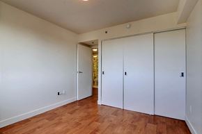 Brossard apartment for rent - a bedroom with two closets and a hard wood floor