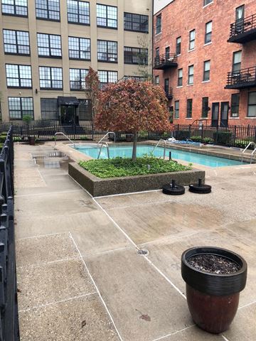 Detroit apartment for rent - a swimming pool in front of an apartment building