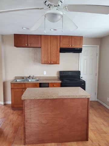 Houston apartment for rent - an empty kitchen with wooden cabinets and a counter top
