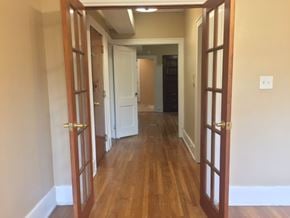 Detroit apartment for rent - A hallway with wooden floors and white walls.