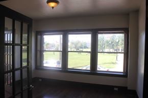 Detroit apartment for rent - A room with a view of a green lawn through the window.