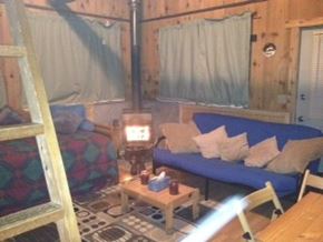 Sterling house for rent - A room with a blue couch and a wooden table.