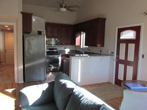 Soldotna apartment for rent - A kitchen with a refrigerator and a couch.
