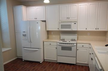 Folsom house for rent - a kitchen with white appliances and white cabinets