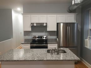 Detroit apartment for rent - a kitchen with a granite counter top and a stainless steel refrigerator