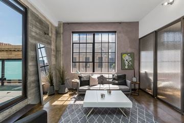 San Francisco apartment for rent - a living room with a large window and a couch and a coffee table