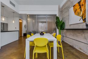 San Francisco apartment for rent - a dining room with yellow chairs and a white table